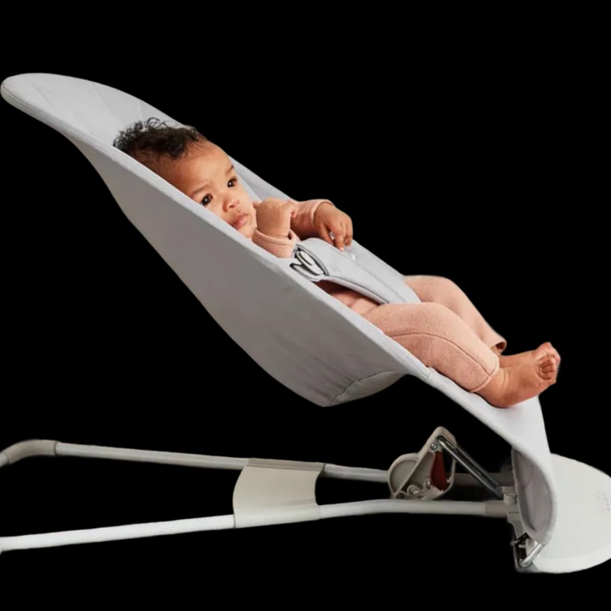 Baby relaxing in the BabyBjörn Balance Bliss bouncer, side view