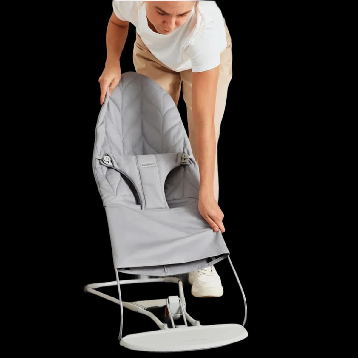Parent folding the BabyBjörn Balance Bliss bouncer flat